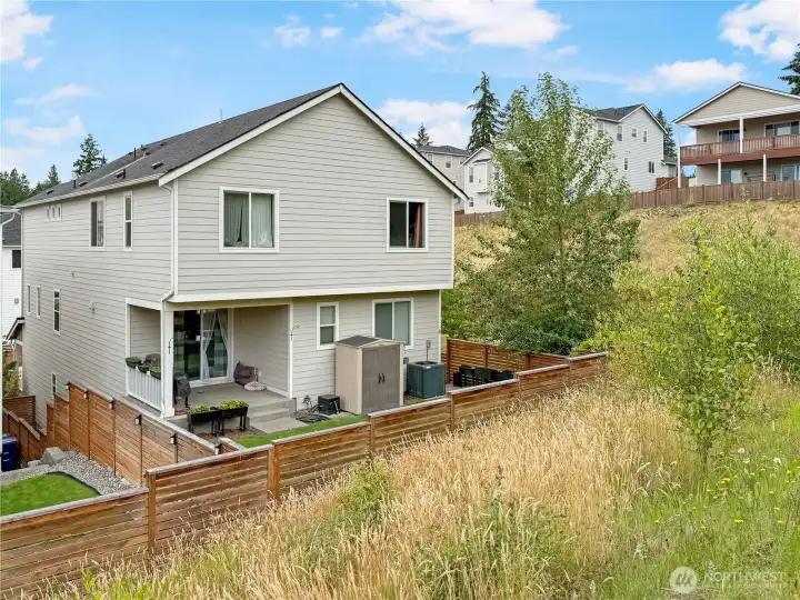 Back yard is fully fenced and includes a helpful storage shed