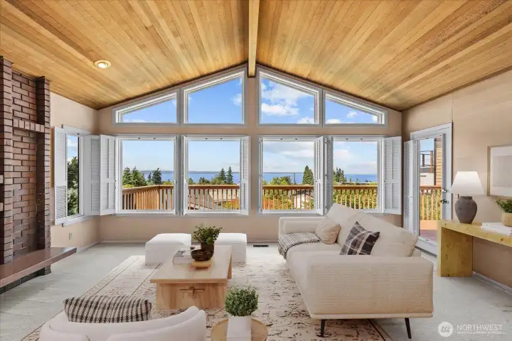 Stunning views from this AI staged living room featuring vaulted ceilings and wood burning fireplace