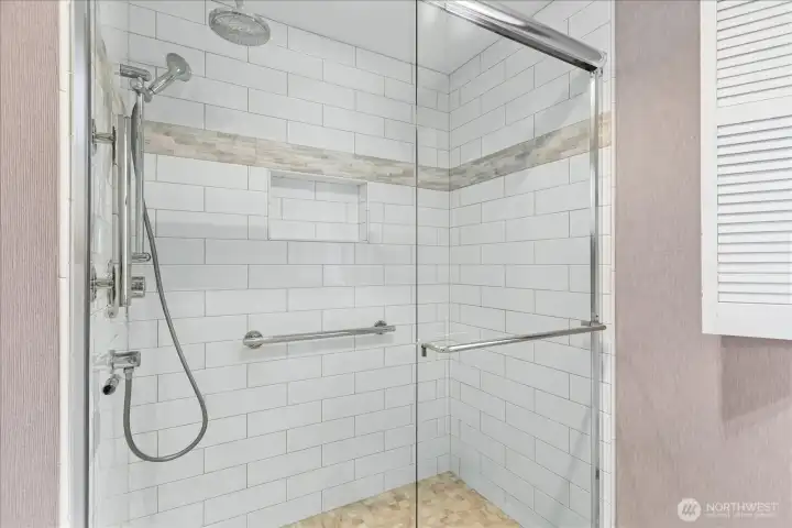 Updated primary bath with tiled shower and private toilet