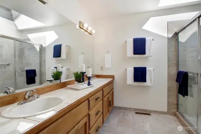 Hallway bathroom with convenient double sinks.