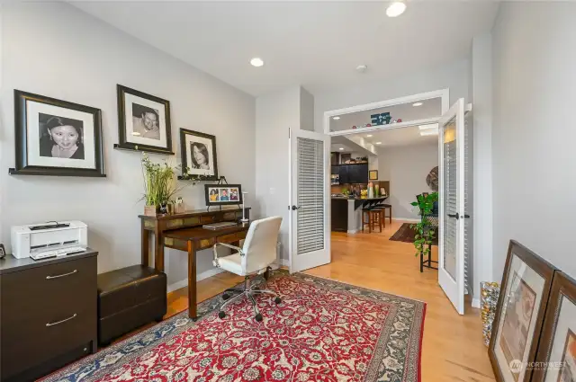 The wood floors are continued in the office creating nice flow from one room to the next. The transom window also lets the natural light transfer from one room to the other.