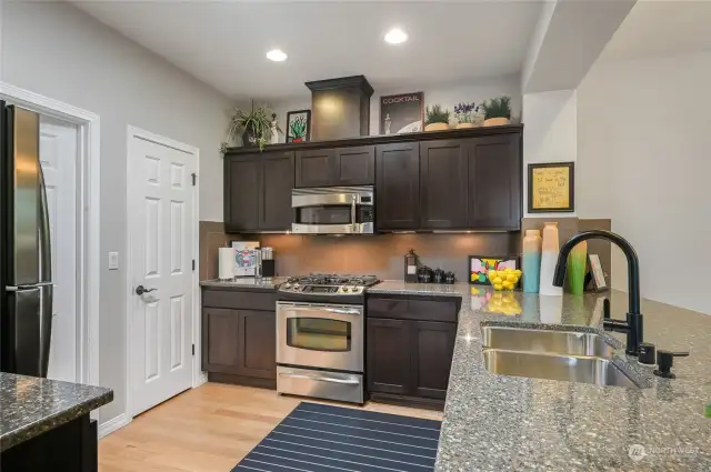 The walk-in pantry is to the left as is the laundry room and entrance to the garage.