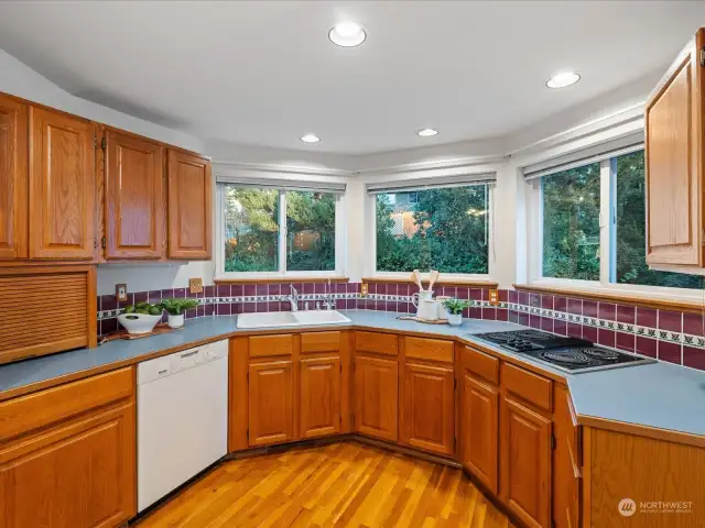 The kitchen looks out over the tranquil backyard