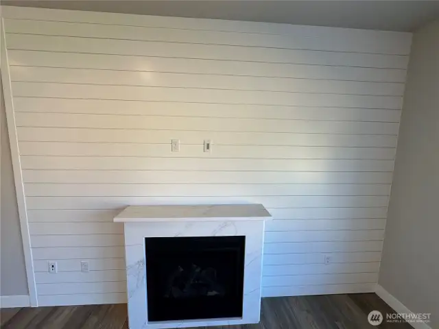 Gas fireplace with shiplap surround and quartz mantel