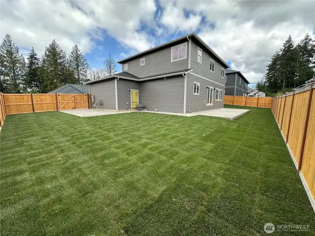 Big backyard with large concrete patio for entertaining