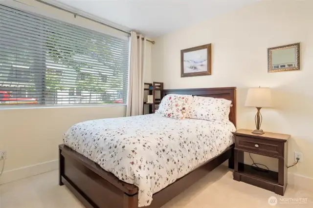 Bedroom Two offers a bright and welcoming space—ideal for guests, a home office, or flex room. The large window brings in abundant natural light while still providing a sense of privacy and comfort.