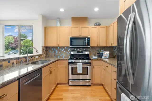 Kitchen includes stainless steel appliances, granite countertops, and ample cabinet storage. Expansive counterspace offers plenty of room to cook, prep, and entertain with ease.