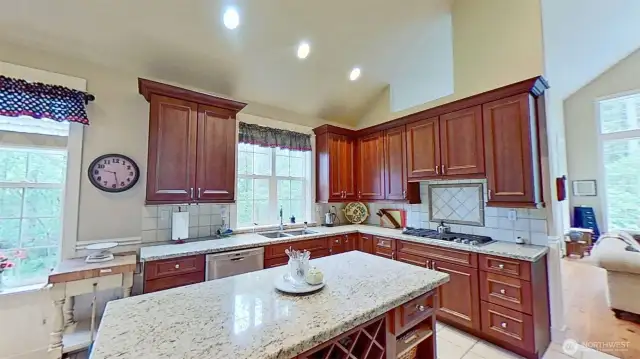 Gorgeous gourmet kitchen with granite counters & island, stainless appliances, well-crafted cabinetry.