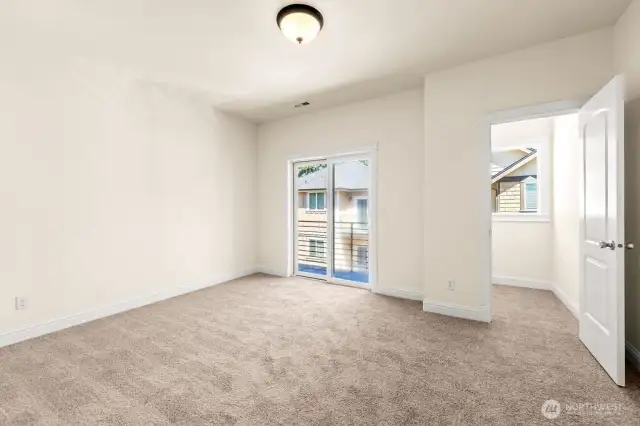 Second additional upper level bedroom with walk-in closet and a balcony