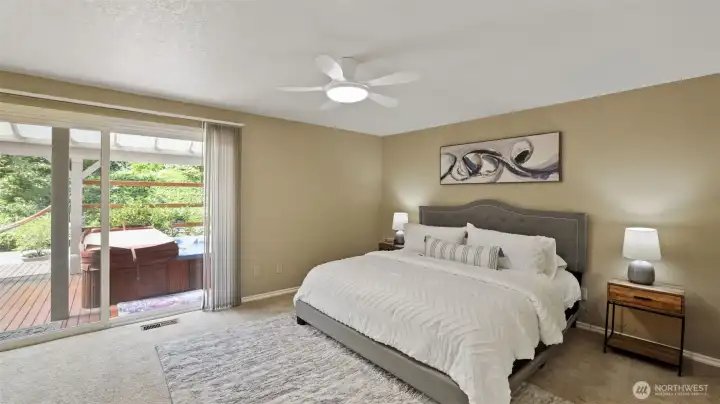 Enjoy private backyard access from the primary bedroom, where a relaxing hot tub awaits just beyond the sliding door.