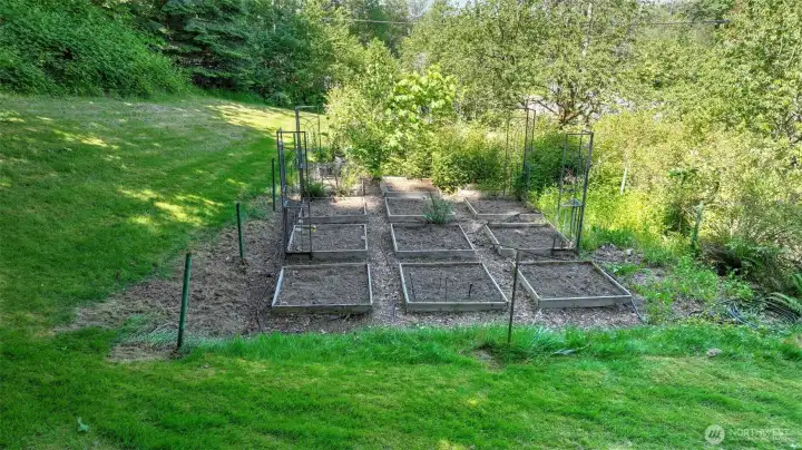 Your homestead awaits! This yard includes a dedicated area designed for gardening and growing your own crops - enjoy already having garden beds, mature cherry trees, blueberry & raspberry bushes, grapes, figs, apples, plums and room for so much more!