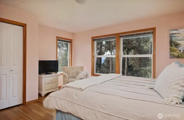 Primary ensuite with two closets, partial views and 3/4 bath.