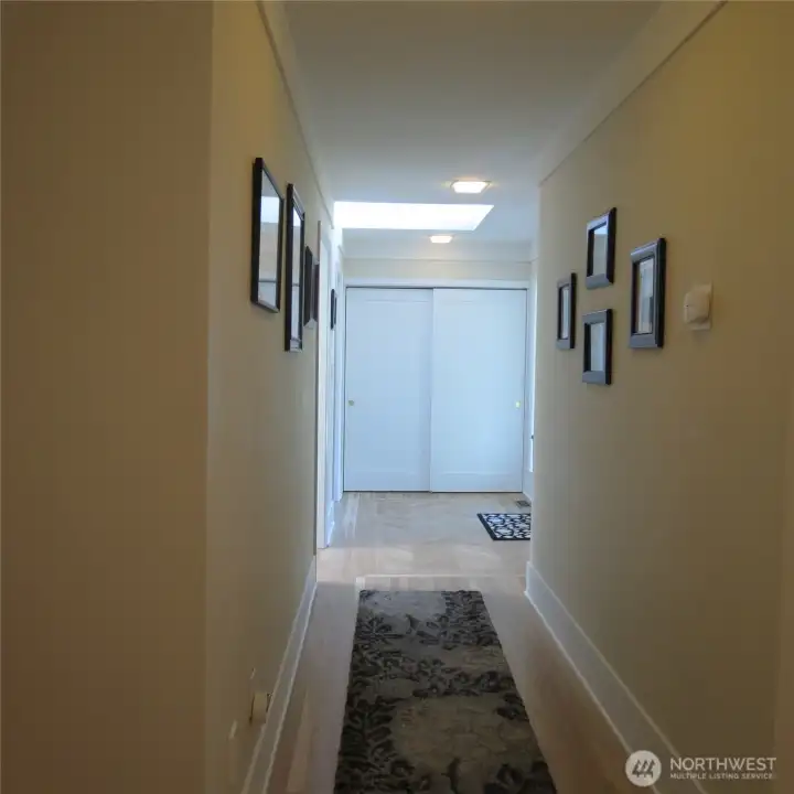Another view of entrance hall area. Note skylight above entrance as well as double closet.