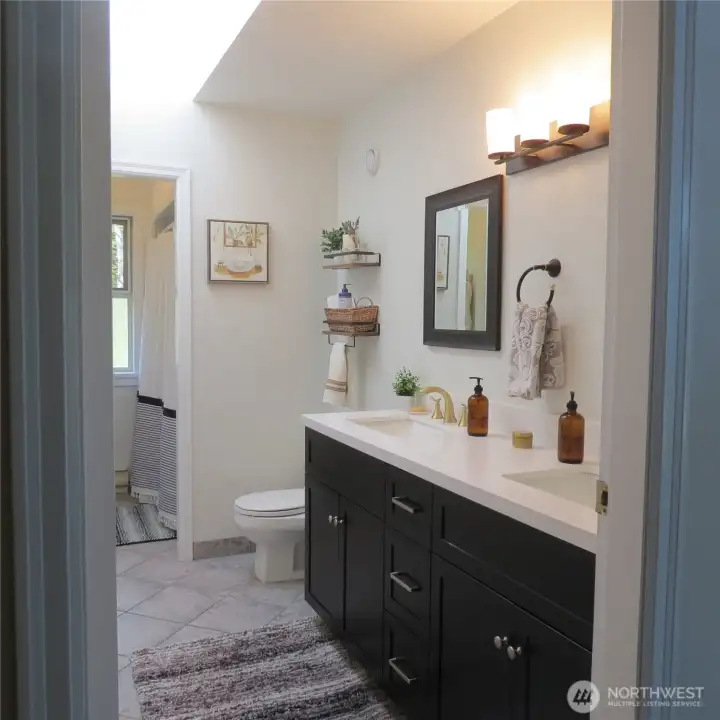 Main level full bath. All new counter, sinks, lighting, etc.