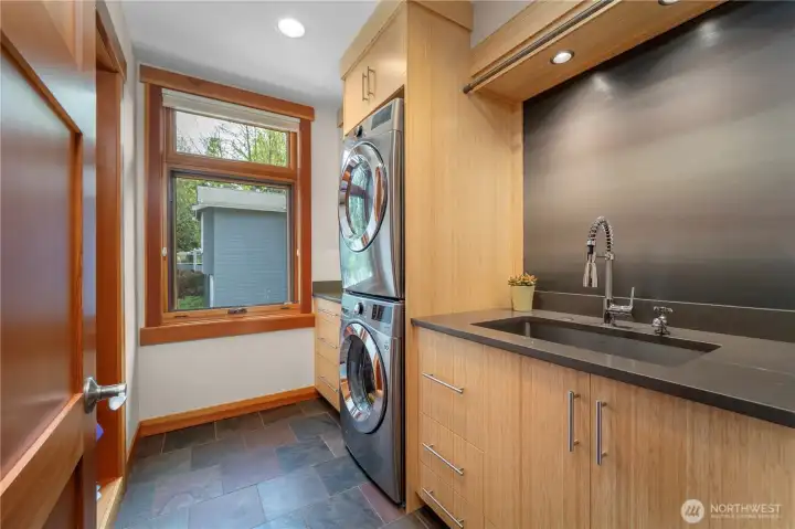 Laundry room with laundry chute and built-in ironing board