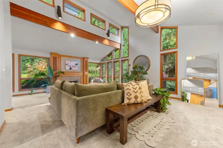 Vaulted ceilings, wood wrapped windows, wood beams and surrounded by nature