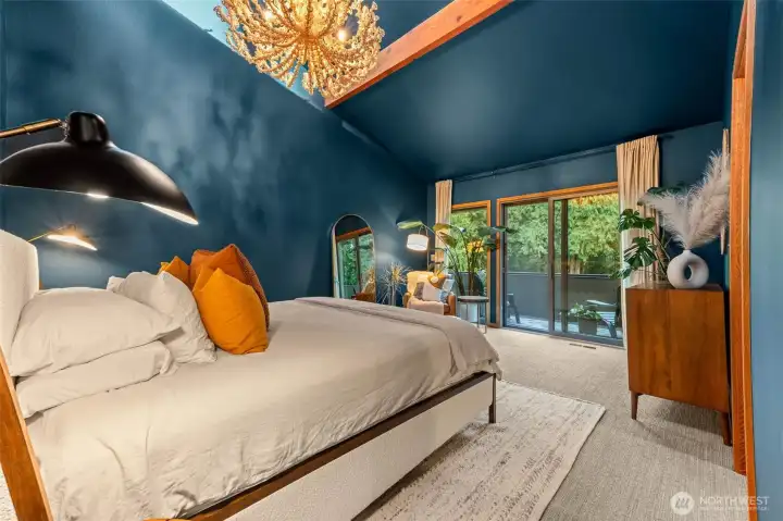 Color drenched primary ensuite with balcony overlooking the estate