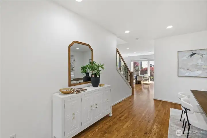 Welcoming entry with hardwood flooring, clean sightlines, and an open flow toward the main living areas.