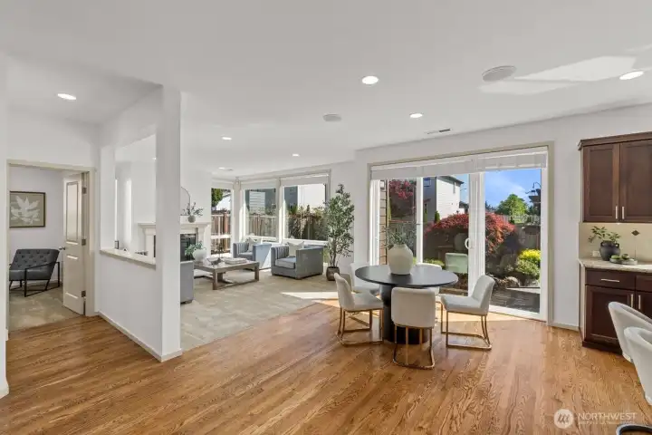 Breakfast Area & Family Room – Open-concept layout with expansive windows, sliding glass doors, and abundant natural light. Comfortable gathering spaces connect seamlessly to outdoor living.