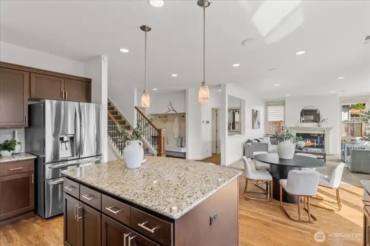 Spacious kitchen with large granite island, extensive cabinet storage, recessed lighting, and open views to the main living areas.