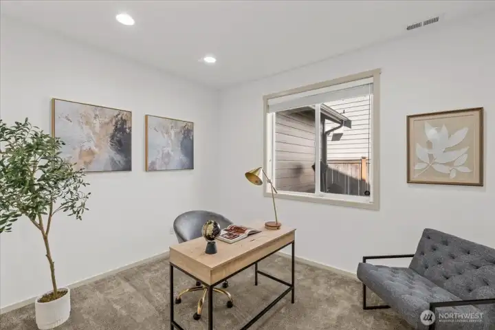 Main-level office/Bedroom or flex space with large window, soft natural light, and comfortable proportions. Ideal for remote work, study, or creative use.