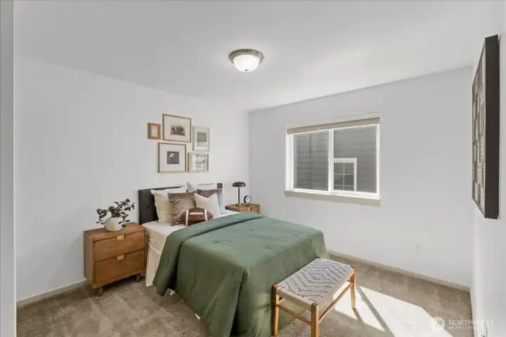 Comfortable secondary bedroom with soft natural light and convenient closet storage. Neutral finishes create a versatile and inviting retreat.