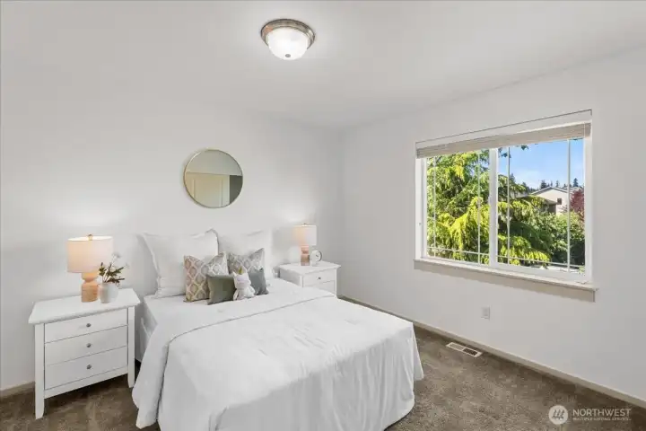 Bright third bedroom featuring large windows, soft natural light, and neutral finishes. Comfortable layout offers flexibility for guests, family, or additional living space.