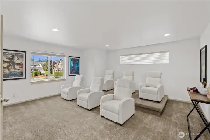 Expansive bonus/media room with tiered seating area, and generous wall space for entertainment setup. Versatile space ideal for movie nights, gaming, or recreation. The platform can be removed.