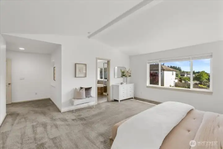 Additional view of the bedroom showcasing comfortable proportions, and an open closet for convenient storage. Large window brings in natural light and enhances the bright, airy feel.