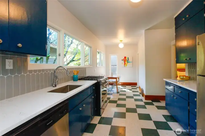 A cheerful eat-in kitchen with original cabinets and gas stove combine character and convenience.