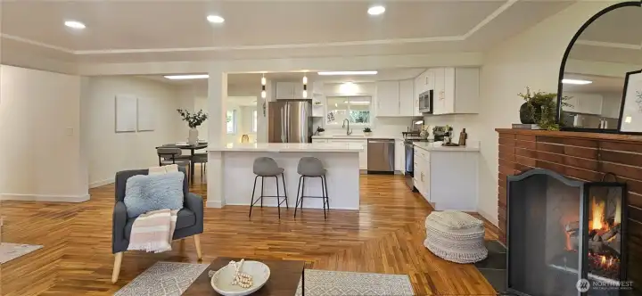 Living Room with Classic Fireplace Opens to Kitchen