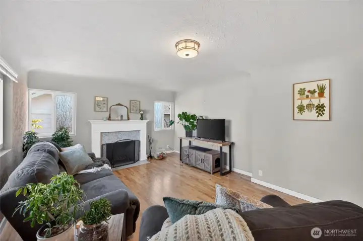 Natural lighting enhances this comfy Living Room with cozy fireplace