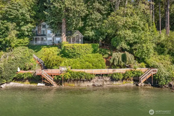 Beautifully positioned above the shoreline, this waterfront compound blends timeless architecture, lush established gardens, and exceptional outdoor living spaces.