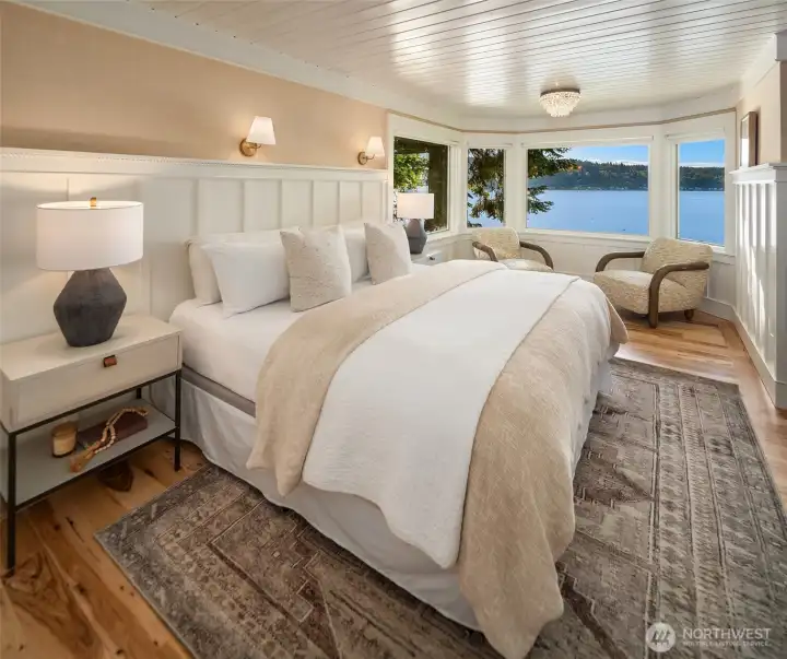 Expansive windows frame ever-changing harbor views from the comfort of the primary suite.
