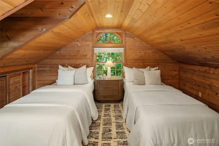 Finished upper-level bonus space with water views, built-in storage, and flexible room for hobbies, recreation, or sleeping quarters.