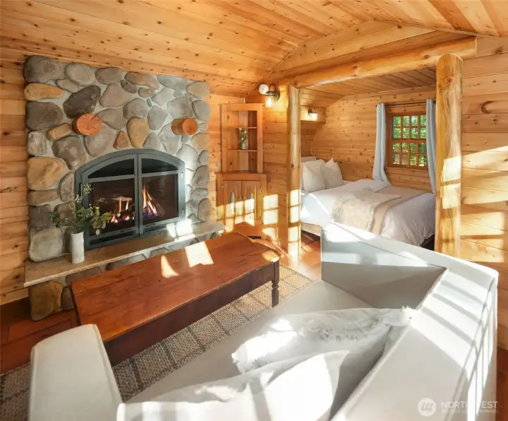 Charming guest sleeping area tucked within the cozy cabin setting.