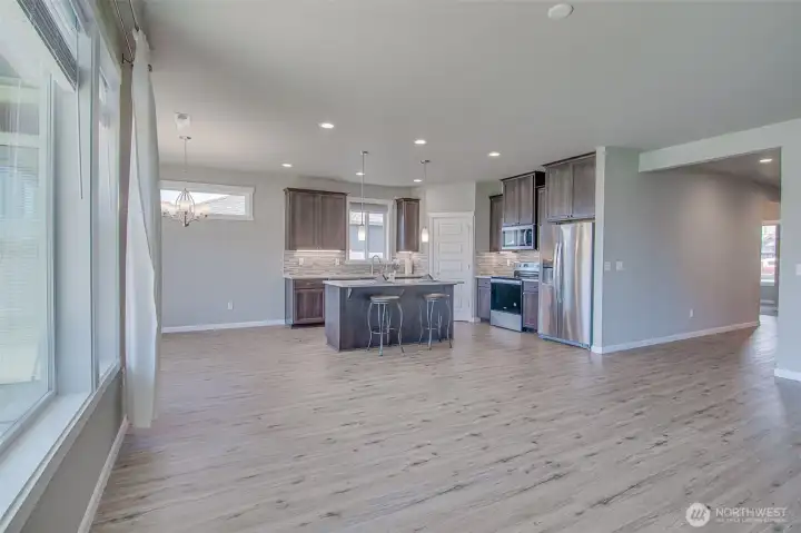 Family Room looking toward Kitchen, and Dining Space.  Ceiling fan connection and forced air vents are shown in the ceiling.