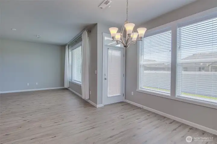Family room, dining space, and door to back patio from kitchen.  The blinds on the back door are new May 2026.