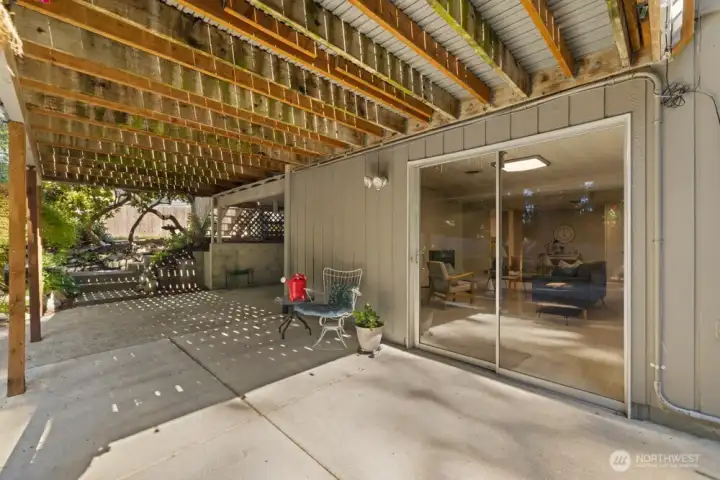 Covered area and slider access to the basement living room