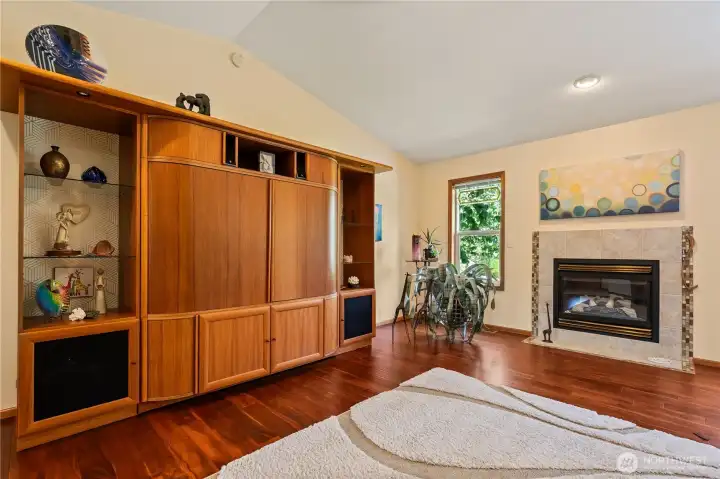 Living room with gas fireplace and hardwood floors.