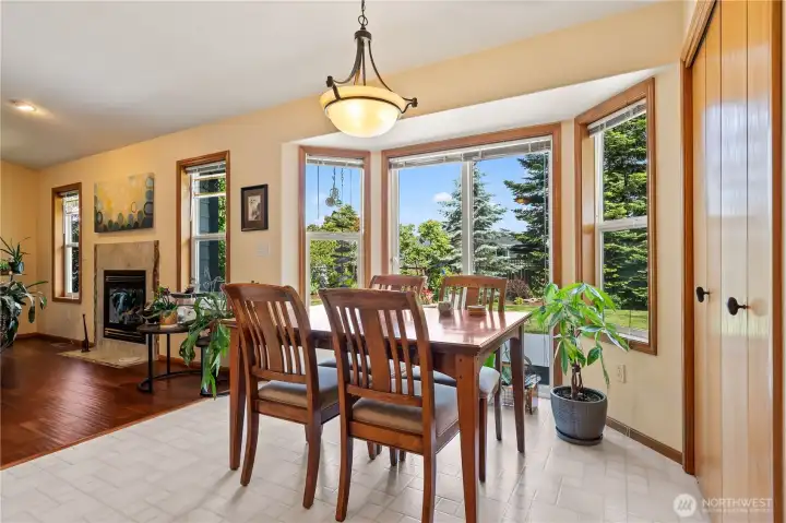 Dining area with bay windows and abundant natural light.