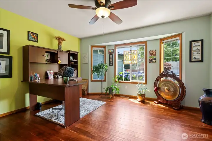 Dedicated home office with large windows and abundant natural light.