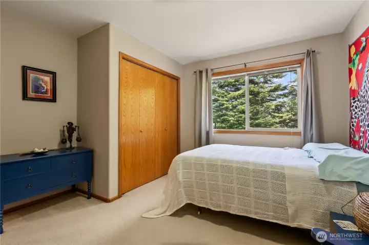 Comfortable guest bedroom with large closet and natural light