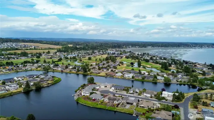Aerial view of Birch Bay Village, showcasing the community’s scenic waterways, marina, and coastal setting.