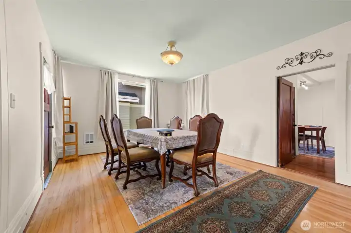 Formal dining area off the living room. Door to the left leads to the wrap-around porch outside. Partial view of the breakfast nook in the kichen to the right in the photo. Formal dining area off the living room. Door to the left leads to the wrap-around porch outside. Partial view of the breakfast nook in the kichen to the right in the photo.
