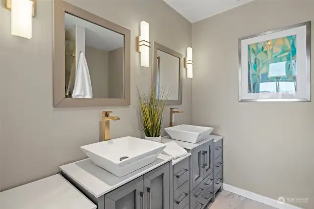 Updated primary bathroom. Stylish finishes and custom cabinetry.