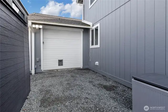 Back side of the Garage with the roll-up door to pass through from the driveway. Or create your own home gym in this bay.