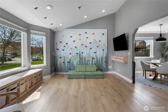 Front Living Room has lots of natural light. The Rock Wall can either stay or go. If the buyers do not want it the sellers will take it down and repair the wall.