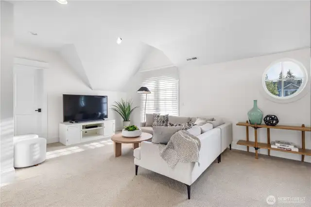 A spacious bonus room upstairs, ideal for a home theater, playroom, or additional living space.
