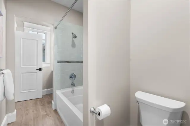 A spacious and beautifully appointed full bath, perfect for family or guests.
